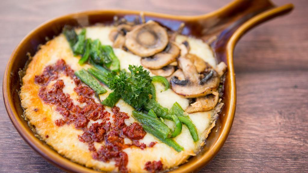 Queso Fundido · Melted oaxaca cheese served with your choice of chorizo, mushroom or rajas (Chile poblano). Served with flour tortillas.