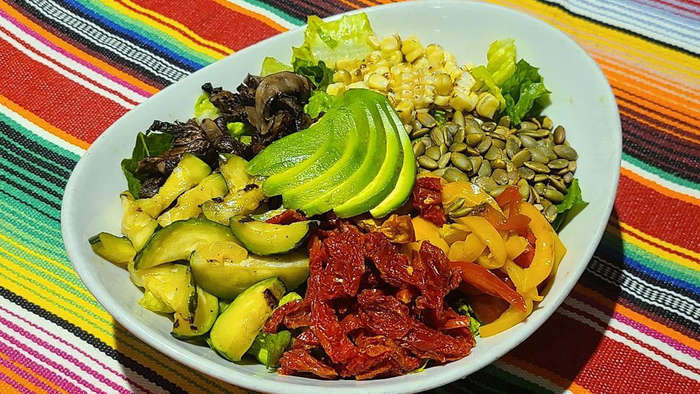 Grilled Veggie Salad · Chef's favorite, vegetarian. Romaine lettuce, avocado, roasted bell peppers, sautéed Portobello mushrooms and zucchini, sun-dried tomatoes, corn kernels, and pumpkin seeds tossed in our house dressing.