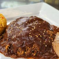 Chicken Mole · Shredded chicken breast covered with a traditional mole sauce. Served with rice, refried bea...