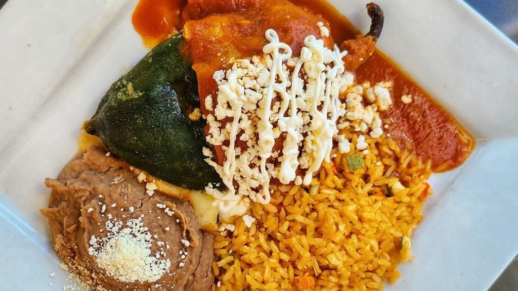 Chile Relleno · Egg battered poblano pepper stuffed with melted monterey jack cheese and corn kernels, covered with a tomato sauce. Served with rice and refried beans.