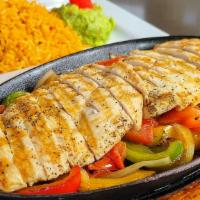 Chicken Fajitas · Grilled chicken tenders with sautéed tomatoes, green bell peppers, and onions. Served with r...