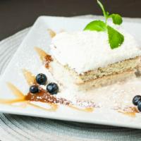 Tres Leches · This distinct cake combines moist and light textures perfectly.  Topped with white chocolate...