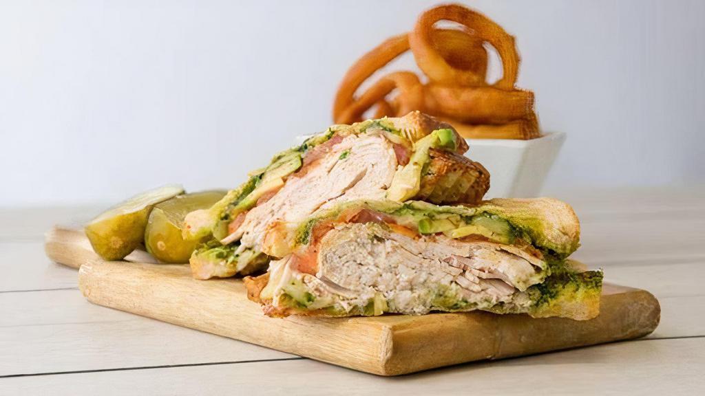 Turkey Pesto Sandwich · Oven roasted turkey, avocado, grilled tomato, muenster cheese, and pesto on sourdough bread.