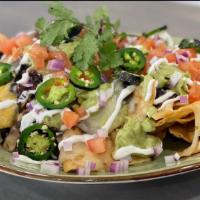 Social Nachos · Tortilla chips, black beans, house cheddar, pepperjack, tomato, red onions, grilled jalapeno...