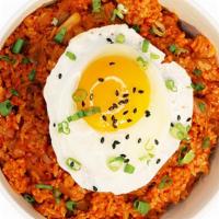 Kimchi Fried Rice · Stir chicken fried rice with vegetables and kimchi base and sunny side egg on top.
