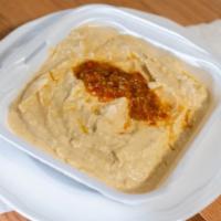 Hummus · Mashed garbanzo beans blended with tahini, olive oil, lemon juice, salt and pepper.