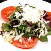 Rugola E Radicchio · Rugola and radicchio lettuce, topped with shaved Parmesan cheese and sliced tomatoes, dresse...