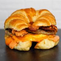 Croissant, Bacon, Sausage, Egg & Cheddar Sandwich · 2 scrambled eggs, melted Cheddar cheese, smoked bacon, breakfast sausage, and Sriracha aioli...