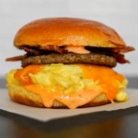 Kaiser Roll, Bacon, Sausage, Egg, & Cheese Sandwich · 2 scrambled eggs, melted cheese, smoked bacon, breakfast sausage, and Sriracha aioli on a wa...