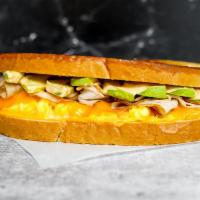 Sourdough, Smoked Turkey, Avocado, Egg, & Cheddar  · 2 scrambled eggs, melted Cheddar cheese, sliced smoked turkey, avocado, and Sriracha aioli o...