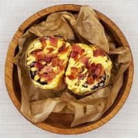 The Brinner Breakfast Burrito · flour tortilla rolled up + stuffed with eggs, bacon, jack cheese, rice, black beans + salsa.