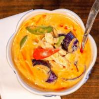 Red Curry · Sliced meat in red curry paste with homemade coconut milk, bamboo shoots, eggplants, bell pe...