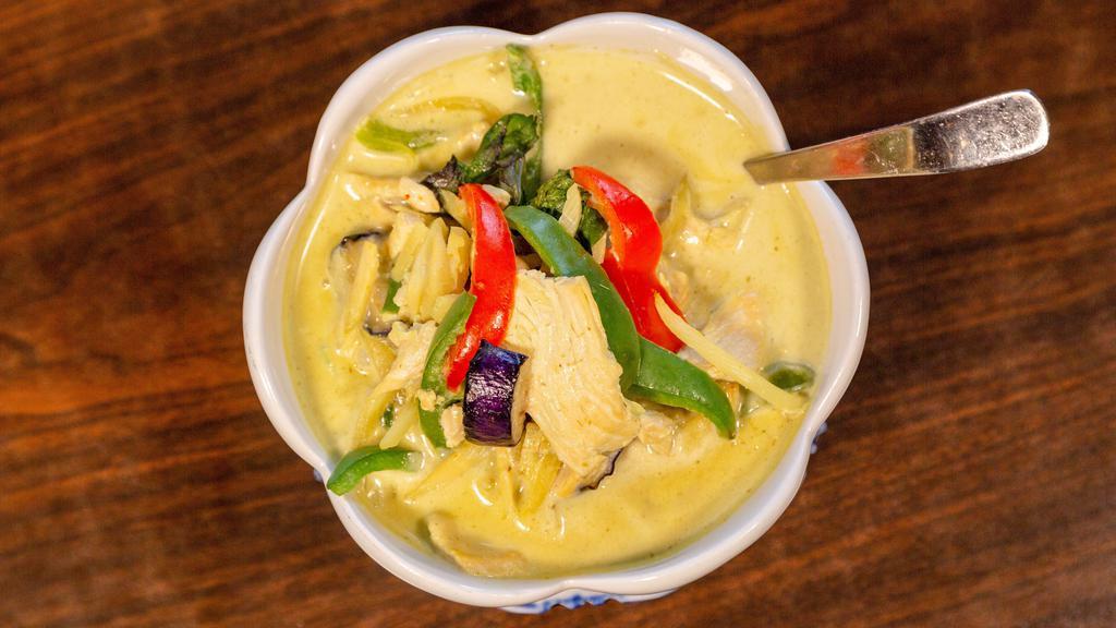 Green Curry · Sliced meat in green curry paste with homemade coconut milk, bamboo shoots, eggplants, bell peppers and basil leaves.