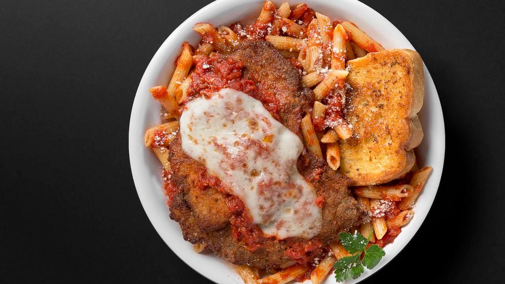 Chicken Parmigiana · Two crispy breaded chicken breasts, topped with tomato sauce, and mozzarella, served with penne marinara.