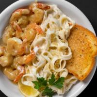 Shrimp Scampi · Eight tiger shrimp sautéed in lemon, wine, butter, and garlic, served with fettuccine alfredo.