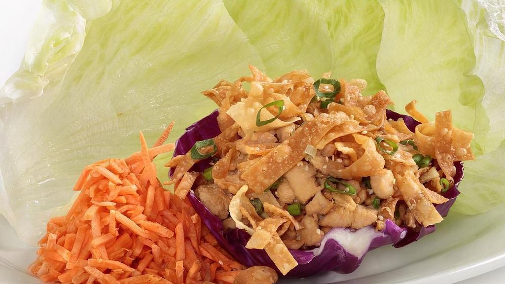 Lettuce Wraps · Marinated diced chicken breast, Julienne carrots, green onion, cashews and wonton strips. Served with iceberg lettuce cups, our own sesame soy sauce and spicy mustard for dipping.