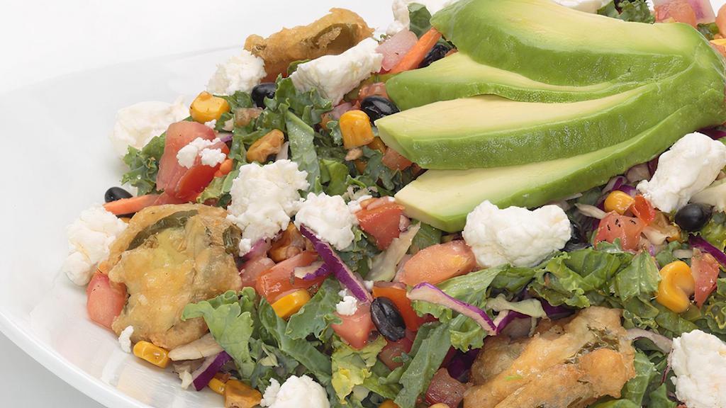 Southwestern Kale Salad  · Thinly sliced kale and cabbage topped with pico de gallo, roasted corn, black beans, avocado, feta cheese, topped with crispy fried jalapeños and finished with our spicy cilantro lime Greek yogurt dressing on the side.  Comes with Oggi's garlic knot.