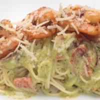 Pesto Shrimp Pasta · Angel Hair pasta tossed in our homemade creamy pesto sauce with sautéed red bell peppers, re...