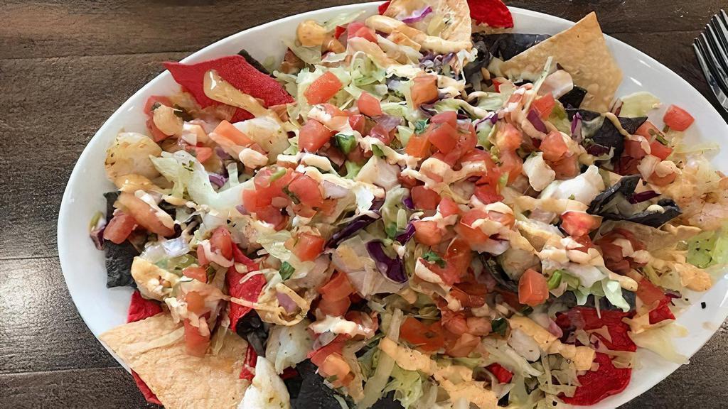Shredded Beef Nachos · Melty nachos loaded with shredded beef, melted cheese, pico de gallo, black beans, and your choice of additional toppings.