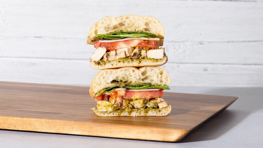 Chicken Pesto · Grilled sliced chicken with fresh mozzarella, sliced tomato, mixed greens, and basil pesto on your choice of bread.