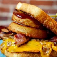 Western Burger · Beef patty w/ melted cheddar cheese, caramelized onions, bacon, onion rings, bbq sauce on a ...