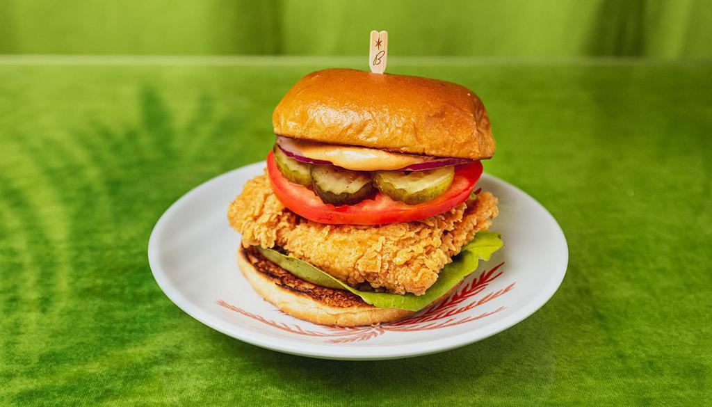 Fried Chicken Sandwich · Crispy chicken breast with tomato, lettuce, onion, pickles, and house sauce.