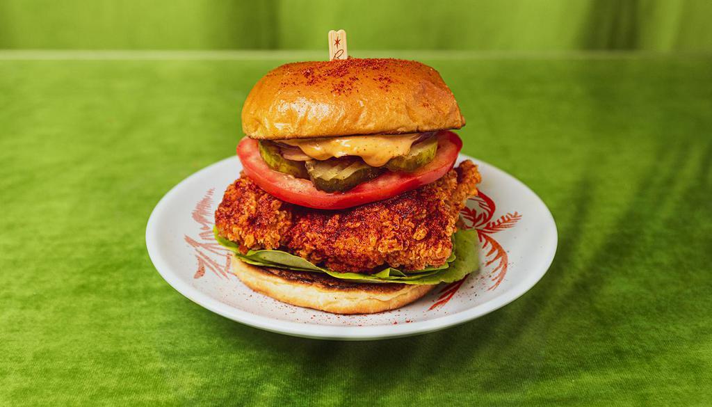 Spicy Fried Chicken Sandwich · Spicy crispy chicken breast with tomato, lettuce, onion, pickles, and house sauce.