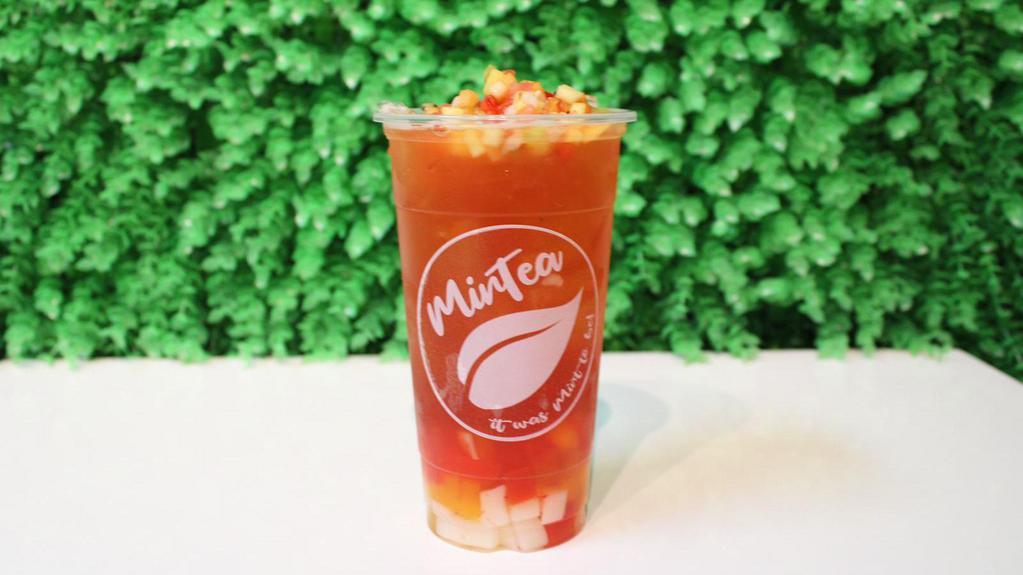 Tropical Iced Tea · Pineapple peach strawberry green tea with rainbow jelly topped with kiwi, strawberry, peach, mango, lychee fruit bits & a mint leaf.