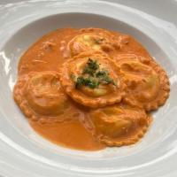 Lobster Ravioli (Guest Favorite!) · Maine lobster and roasted fennel filled ravioli, creamy tomato vodka pink sauce with butterf...