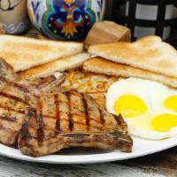 Pork Chop & Eggs Breakfast · Two pork chops,  two eggs,  hashbrown and 2 slices of toast and jelly.