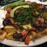 Carne Asada Fries · French fries covered with nacho cheese, refried beans, cilantro, tomato, jalapeno and sourcr...