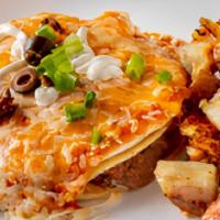 Huevos Rancheros Con Papas · Two eggs on a soft corn tortilla with our homemade pinto beans, smothered with our salsa and...