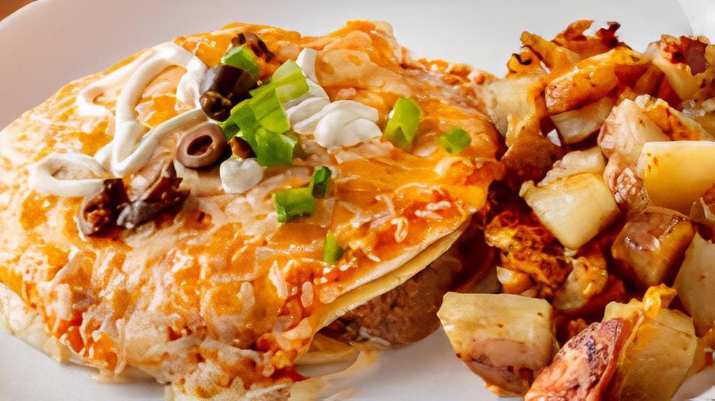 Huevos Rancheros Con Papas · Two eggs on a soft corn tortilla with our homemade pinto beans, smothered with our salsa and topped with cheese, sour cream, green onions, and olives.  Served with your choice of side.