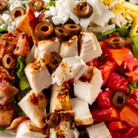 Cobb Salad · Crisp greens topped with chicken breast, olives, bleu cheese, bacon, hard-boiled egg, tomato...