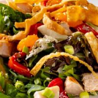 Asian Chicken Salad · A sesame ginger dressing tossed with crisp greens, grilled chicken, roasted red peppers, and...