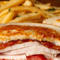 Classic Turkey Melt · On grilled Parmesan sourdough bread with melted cheese, tomatoes, and thick-cut bacon.