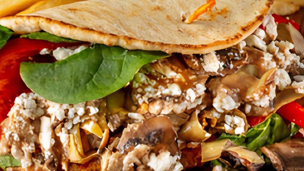 Incredible Artichoke Sandwich · Sauteed artichoke hearts and mushrooms, fresh spinach, tomatoes, and roasted red peppers on delicious pita bread with mayonnaise, feta cheese, and balsamic vinaigrette.