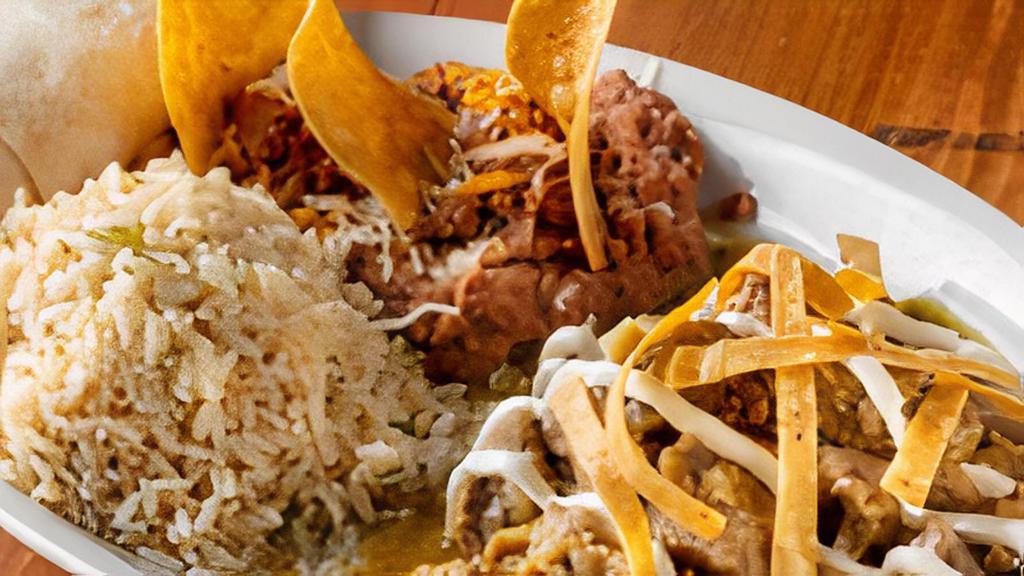 Authentic Chile Verde · Tender chunks of pork simmered in our traditional tomatillo sauce with green chile and onions. Topped with sabritas and sour cream, and served with warm flour tortillas.