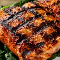 Wild Grilled Alaskan Salmon · Slightly spicy seasoning served on a bed of sauteed spinach with your choice of side. (Serve...