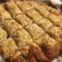 Roasted Garlic Cheese Bread · Our specialty blend dough topped with buttery house roasted garlic cloves and garlic oil