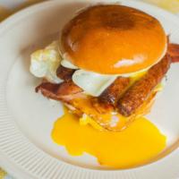 The Big Breakfast Sandwich · Toasted brioche bun with two Eggs, Bacon, Ham, Sausage, Mozzarella, and American Cheese.