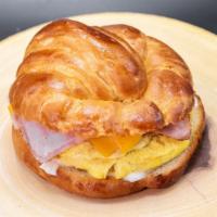 Our Famous Breakfast Croissant · Choice of meat (ham, bacon or chorizo), egg, American cheese and jalapenos.
