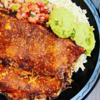 Grilled Enchiladas · Two corn tortillas grilled with enchilada sauce filled with melted cheese and your choice of...