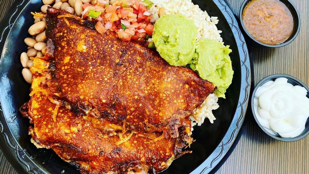 Grilled Enchiladas · Two corn tortillas grilled with enchilada sauce filled with melted cheese and your choice of meat.  Served with rice and beans & any toppings.