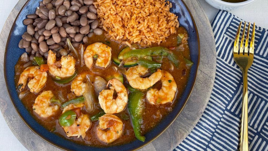 Camarones Rancheros · Fresh shrimp cooked in jalapeño butter, sautéed vegetables, pico de gallo, and a blend of our three (3) homemade sauces.  Served with rice, beans, and your choice of corn or flour tortillas.