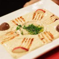 Hummus · A smooth, creamy garbanzo beans spread. Served with pita bread.