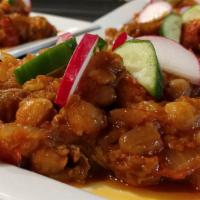 Mousakaa · Fresh eggplant baked with tomato, onion, garbanzo beans, and green peppers (served cold).