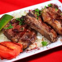 Lamb Chops Entree · Mouth-watering lamb chops (4), char-grilled and served over basmati rice with hummus OR  mas...