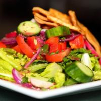 Fattoush Dinner Salad · Crisp romaine, tomato, peppers, radish, fresh mint, scallions, cucumber and pita crisps, tos...