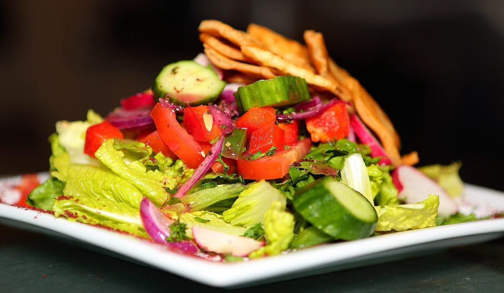 Fattoush Dinner Salad · Crisp romaine, tomato, peppers, radish, fresh mint, scallions, cucumber and pita crisps, tossed with our citrus sumac dressing.
Top Salad with grilled chicken breast $5